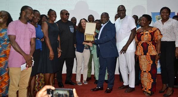 • Mr Nikoi (fourth from right) being assisted by other members of the assembly to receive the award Photo: Victor A. Buxton