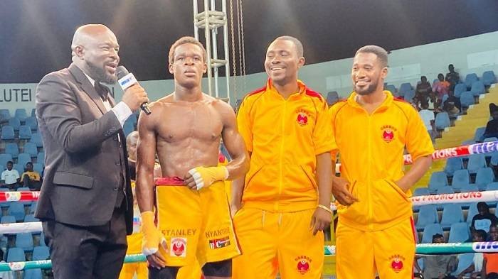 Nyantakyi (second left) answering questions from the ring announcer. Looking on were his cornermen