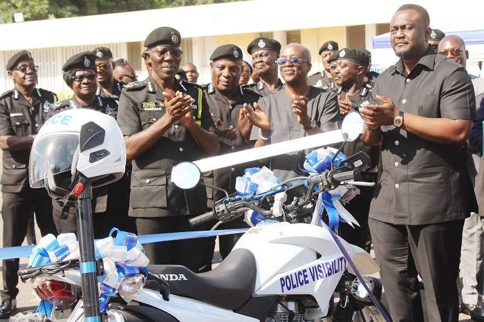 (inset) IGP,Dr George Akuffo Dampare (left),Mr Keli Gadzekpo (second from right) and Mr Samuel Dubik(right) applauding after the presentation of the motorbikes. Photo. Ebo Gorman