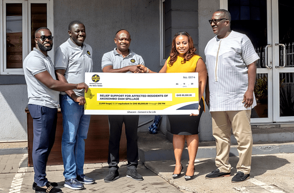 • Mr Kyere (middle) handing over the chit for the cement to the Citi FM team