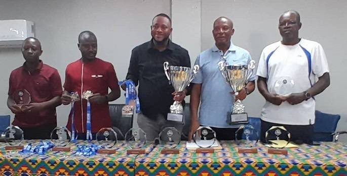 Mohammed Awudu Aputeog (third left) together with Mr. Awuku Akuffo display the trophies and medals together with other invited guest