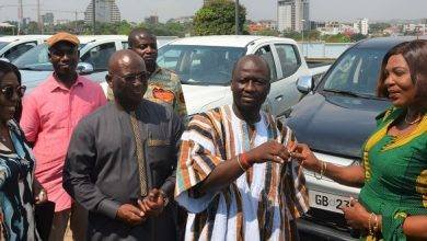 Mr Frederick O. Adom, Deputy Transport Minister (in smock), handing over the keys to the vehicles to Mrs Elizabeth Sackey on behalf of the beneficiaries Photo: Godwin Ofosu-Acheampong