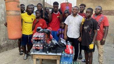 Mr Kotey (In white shirt) with Coach Armah and some of the boxers at the gym after the presentation