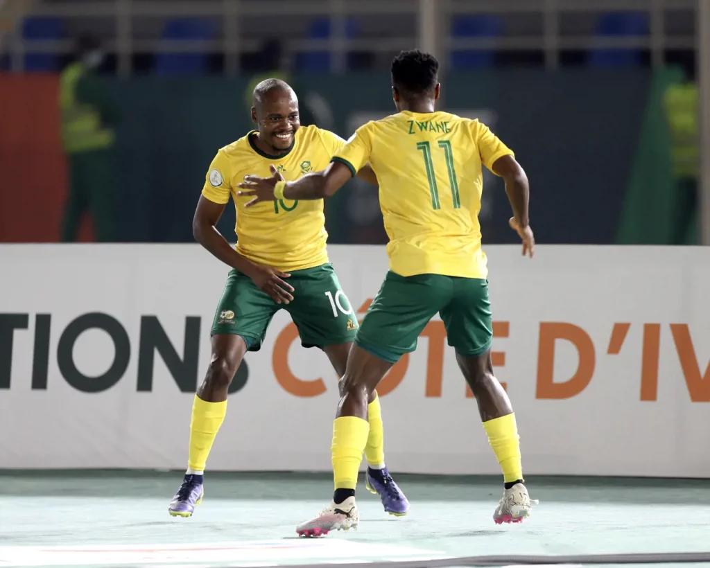 • Percy Tau and Zwane celebrating the team's opener