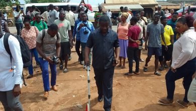 • Mr Odoi (middle) measuring distance from the road to an immediate property Photo: Lawrence Akpalu