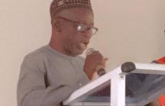 Mr Tengan (inset) addressing participants in the launch