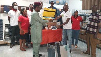 Mr Raaj (left) presenting the items to Dr Imoro (right)