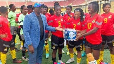 • Mr Nunoo Mensah presenting water to skipper Portia Boakye, while other members of the team look on