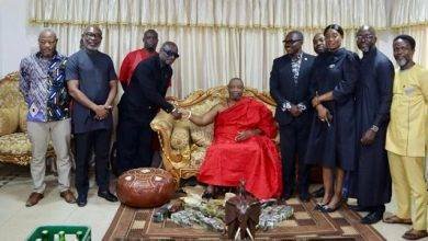 Mr Reks Brobbey in a handshake with the Ga mantse while members of the LOC look on