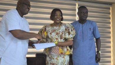 Ms Elisabeth Sackey, AMA Mayor (middle) handing over her signed document to Mr Quartey while Mr Douglas Annoful, the Coordinating Director looks on  Photo: Godwin Ofosu Acheampong 