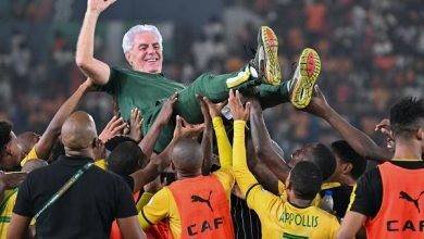 • South Africa players celebrating with coach Hugo Broos after the game