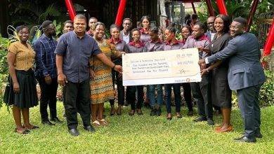 The beneficiaries receiving their cheques