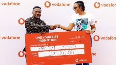• Mr Yawo (left) receiving his prize from a Vodafone Ghana official