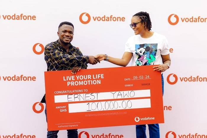 • Mr Yawo (left) receiving his prize from a Vodafone Ghana official