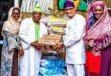 Dr Mustapha Abdul-Hamid (second from right) presenting the items to a representative of Chief Imam