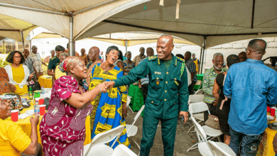 THE COMPTROLLER GENERAL OF IMMIGRATION CONGRATULATING NEWLY APPOINTED EXECUTIVES AT THE CEREMONY