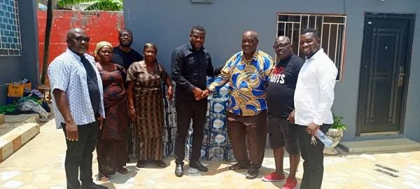 Uncle Joe Boye (third right) making the donation to Awuley Quaye Jnr while other members of AGOSU and the family look on