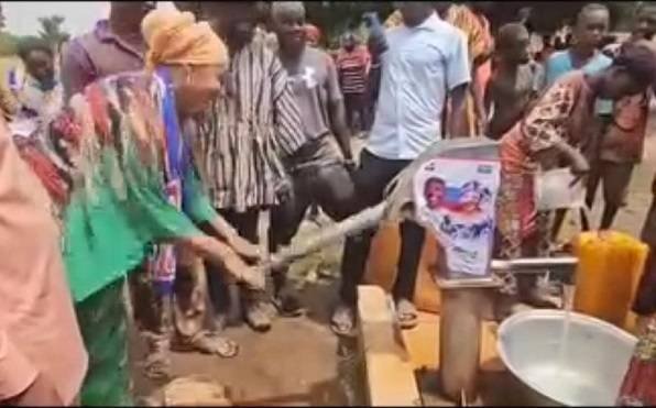 • Mrs Felecia Tettey trying her hands on the borehole machine