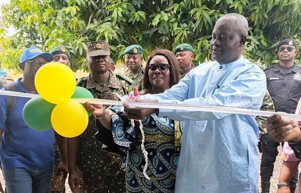 • Inset: Mrs Eyiah (middle) being assisted by other dignitaries to cut the tape to unveil the renovated project