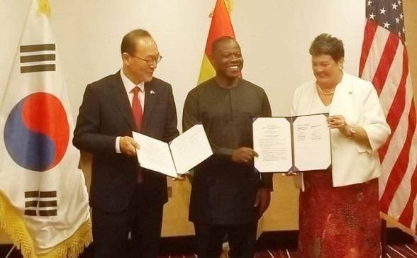 Mr Kyongsig (left) and Ms Palmer (right) with the MOU. With them is Mr Aboagye