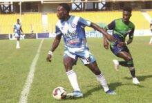 • Oly’s Richard Botchwey (left) controls the ball away from Chelsea’s Stephen Amankona