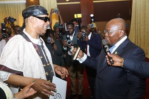 President Akufo-Addo (right) presenting the passport to Steve Wonder to indicate his citizenship