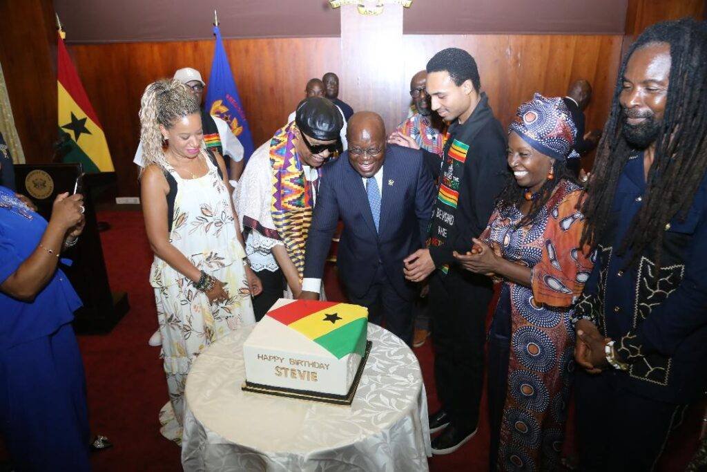 •
President Akufo-Addo (fourth from right) assisting Stevie Wonder (second from left) to cut his birthday cake at the Jubilee House