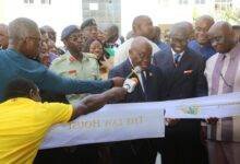 President Akufo-Addo (middle), being assited by Mr Godfred Dame (second from right) and other dignitaries to cut the ribbon for the inauguration of the Law house