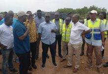 • Inset: Mr Francis Asenso-Boakye (middle) inspecting the ongoing work. With him are some engineers assigned to the construction of the road