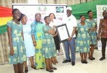 Mr. Kwaku Ampratwum-Sarpong (fourth from right) presenting the overall winner prize to a student of Accra Girls SHS .Photo. Ebo Gorman