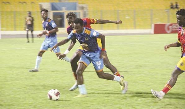 • Nations FC’s Victor Oduro tries to outwit Kassim Cisse of Hearts in their 32nd week GPL match Photo: Raymond Ackumey