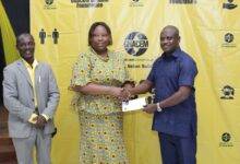 Mr Kwasi Kyere (Right) hands over cement allocation chit to representative of a beneficiary Institution.