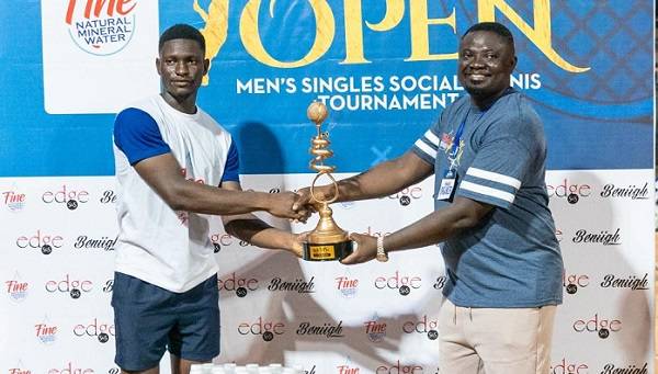 • The champion, Nartey, (left) receiving the trophy from, Mr Joseph Nii Armah, CEO of Fine Natural Mineral Water