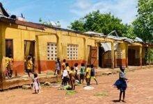 One of the ripped off classroom Blocks with pupils playing around it