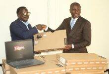 Mr Alexander Afenyo-Markin (right) presenting the laptops to Mr Martin Adu-Owusu,MD, NTC. Photo. Ebo Gorman