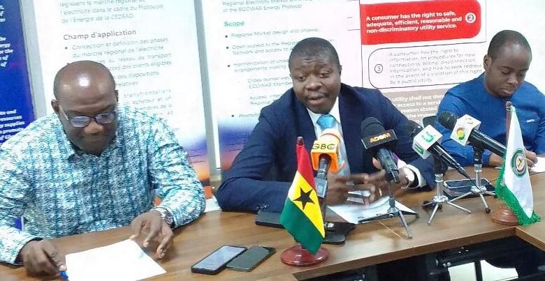 Mr Tossou (middle) addressing the press