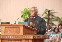 Reverend Dr Fred Degbee (inset) addressing the congregation