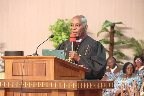 Reverend Dr Fred Degbee (inset) addressing the congregation