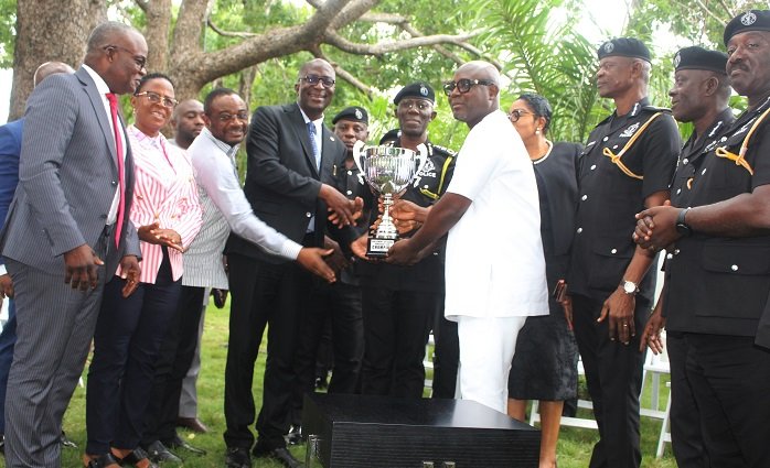 • Mr Asiamah (fourth from left) presenting Democracy Cup to Dr Dampare (middle). With them are some members of POMAB and members of the delegation from Parliament