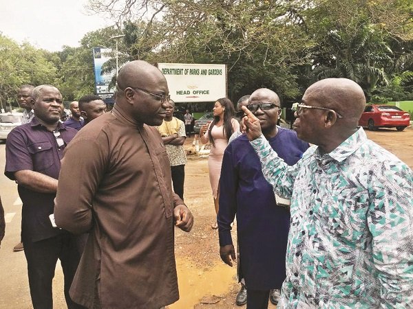 Mr Korsah (left) receiving briefing from some officials of the Department