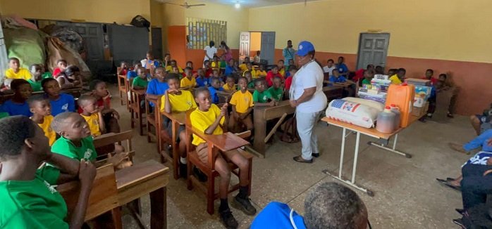 • Ms Addoquaye interacting with the children