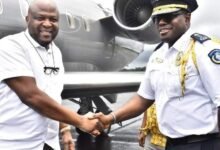 Mr Mahama (left) handing over the vehicles to Liberian authorities