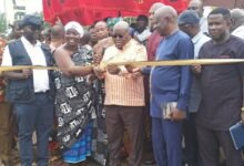 President Akufo-Addo (middle) cutting the tape to officially open the road for use