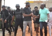 • Mr Titus Glover (second from right) interacting with some of the arrested people. With them are Mr Solomon Kotey Nikoi ( right) and others Photo:Victor A. Buxton