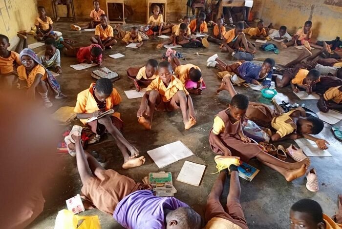 • Some of the pupils lying on their stomachs on the bare classroom floor during school hours