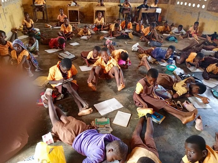 • Some of the pupils lying on their stomachs on the bare classroom floor during school hours