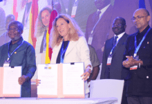 Ms Myriam Ferran , and Dr Anthony Nsiah Asare showing the agreement after the signing. Applauding is Mr Irchad Razaaly, European Union Ambassador to Ghana.Photo. Ebo Gorman