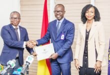 • Seun Layade, Head of Project Management & Corporate Development and Acting Head of Technical and Professional Services at CWG Ghana (left) receiving the certificate or license from Dr Albert Antwi-Boasiako, Director General, CSA