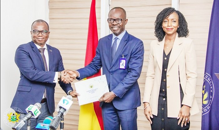 • Seun Layade, Head of Project Management & Corporate Development and Acting Head of Technical and Professional Services at CWG Ghana (left) receiving the certificate or license from Dr Albert Antwi-Boasiako, Director General, CSA