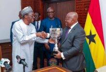 • Speaker Bagbin (left) handing over the cup to President Akufo-Addo